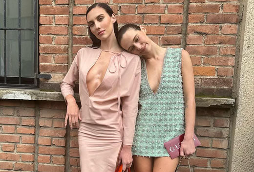 Devon and Sydney Carlson pose against a brick wall
