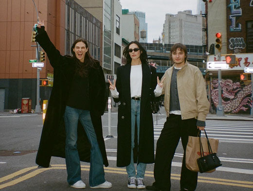 Devon and Sydney Carlson pose in the street with Dean Dicriscio