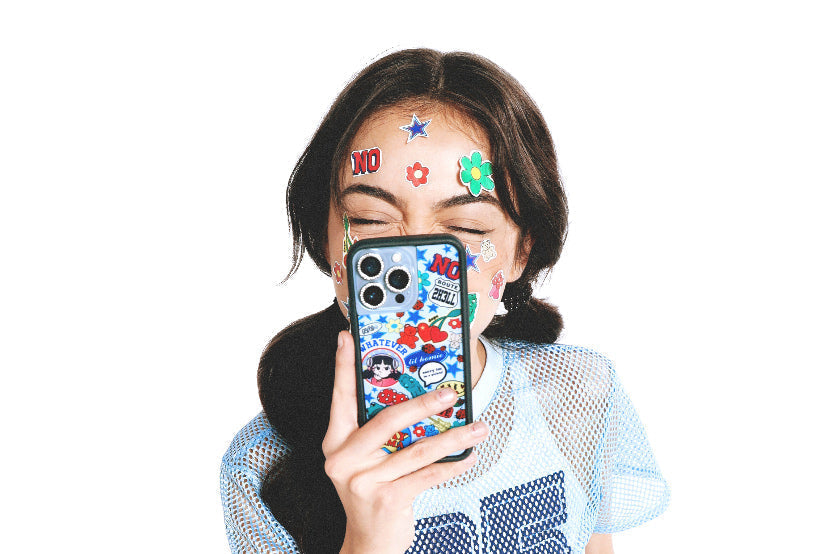 Nailea Devora poses with stickers on her face and holding her custom WF case