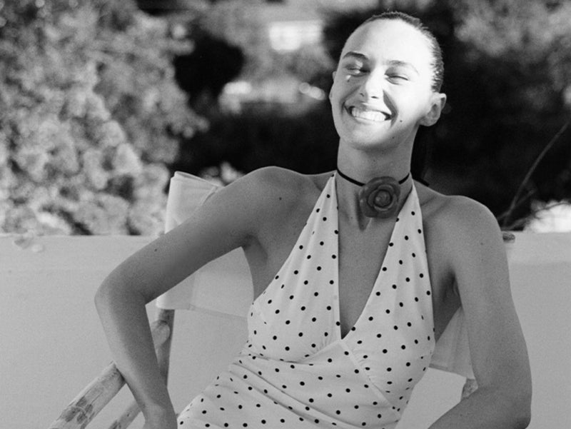 Black and white photo of Devon Lee Carlson in a polka dot dress
