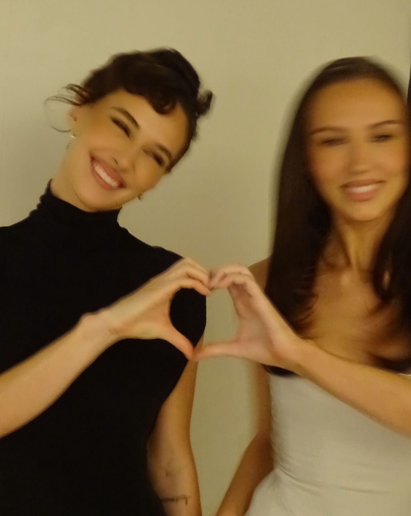 Devon and Sydney Carlson hold their hands together to form heart